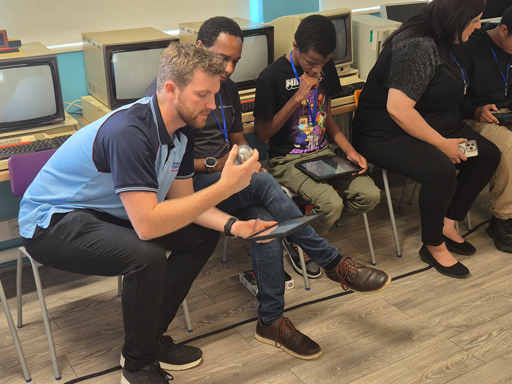 A student group engaged in programming their robot
